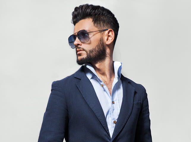 A man in suit wearing sunglasses